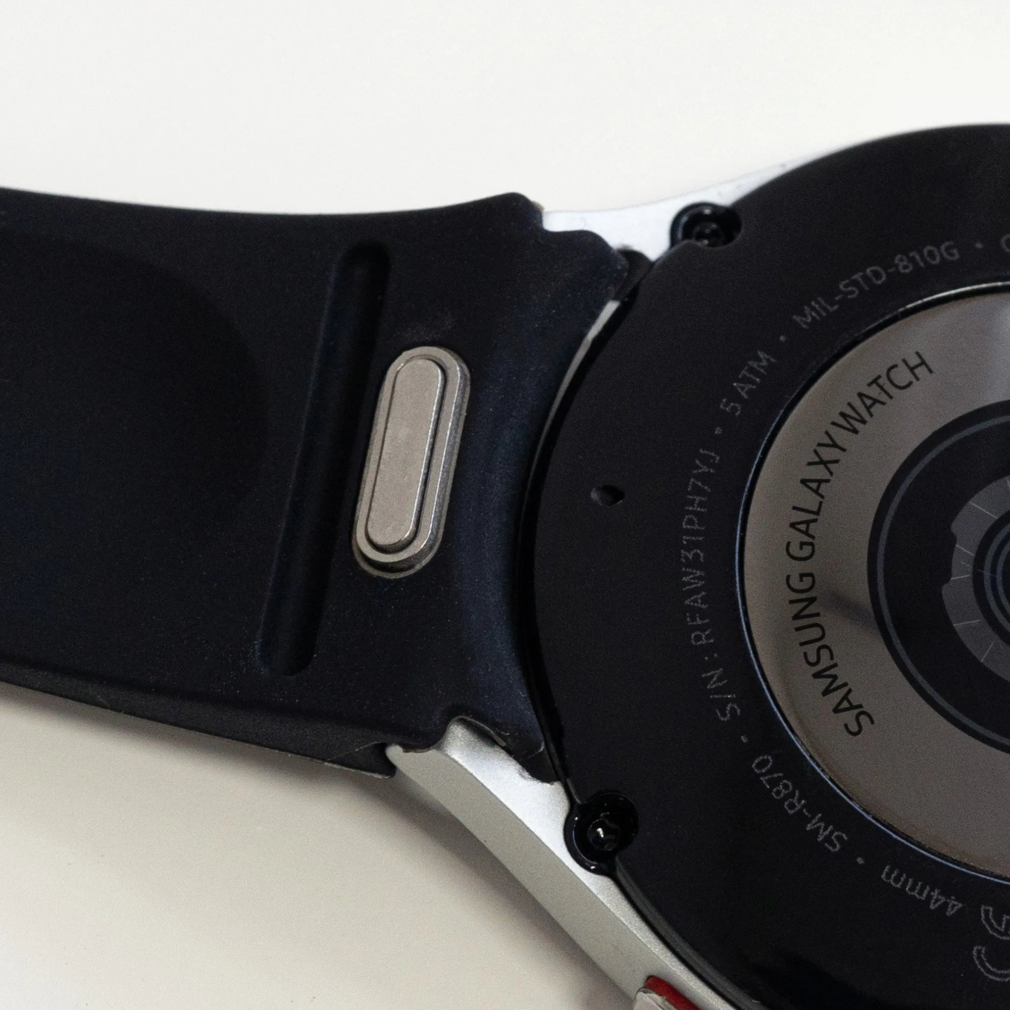 Silicone Strap 'One Push', black, on a watch, 3/4 rear view